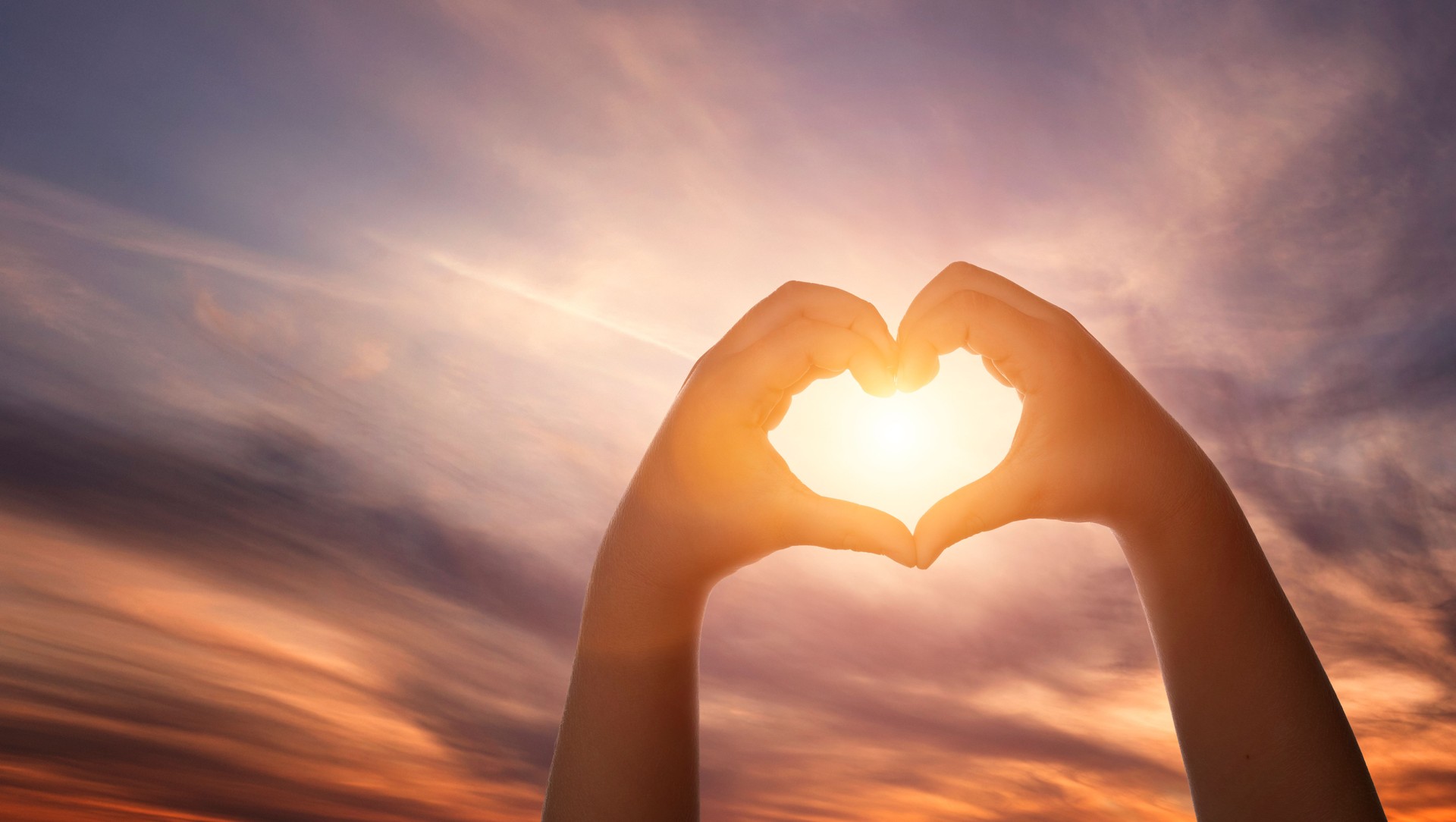 Child hands forming heart shape.